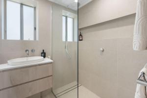 a bathroom with a sink and a shower at Hydra - 3 Bedrooms, Ocean views, Pool in Sunshine Beach +20 photos