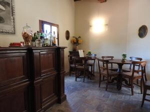a dining room with a wooden table and chairs at Relais Borgo Di Toiano in Sovicille