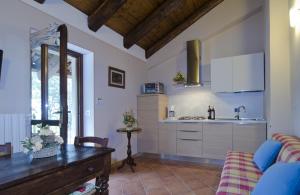 a kitchen with a table and a sink in a room at Sul Bric Dei Capalot in La Morra
