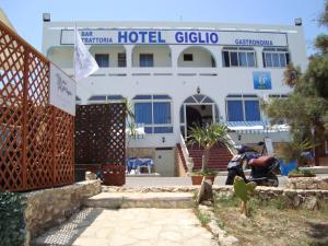 a hotel building with a scooter in front of it at Hotel Giglio in Lampedusa