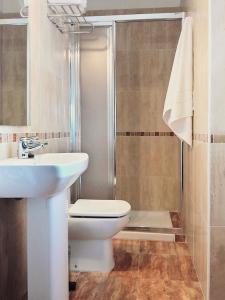 a bathroom with a toilet and a sink and a shower at Hotel El Panorama in Tapia de Casariego +51 photos