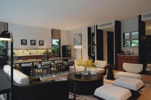 a living room with a couch and chairs and a table at Argo Pattaya Resort and Villas in Ban Huai Yai
