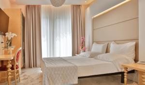 a bedroom with a large bed and a large window at Hotel Ambassador in Rimini