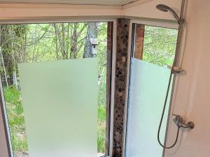 a window in a bathroom with a shower at 4 star holiday home in Grimstad in Grimstad