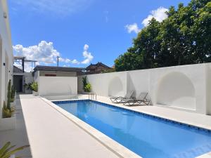 a swimming pool in the backyard of a house at Apartemen JIRO BALI in Ngurah Rai International Airport