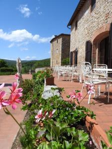 a garden filled with lots of flowers next to a building at Relais Borgo Di Toiano in Sovicille