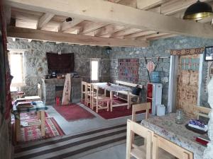 a kitchen and dining room with a table and chairs at Bucolic River Resort in Gulmit +30 photos