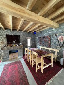 a dining room with a table and a fireplace at Bucolic River Resort in Gulmit