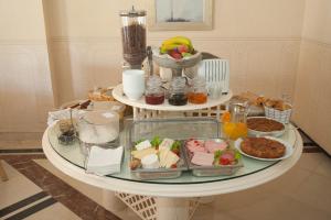 a table with plates of food on top of it at Hotel Kalafati in Itea