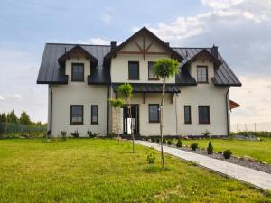 a large white house with a black roof at Villa Terra in Nałęczów
