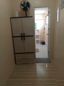 a room with a closet with a dresser and a hallway at A Scandinavian Staycation - ROMA 1616 in Mactan Island +41 photos