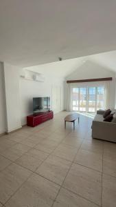a living room with a couch and a tv at Exclusive Master Apartment in Adeje