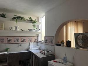 a kitchen with a counter and a sink and a window at Salerno in Chiclayo