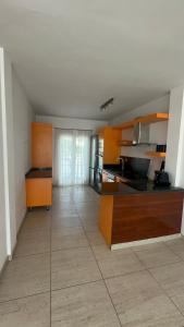 a large kitchen with orange cabinets and a floor at Exclusive Master Apartment in Adeje