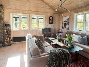 a living room with a couch and a table at 10 person holiday home in veggli-By Traum in Veggli