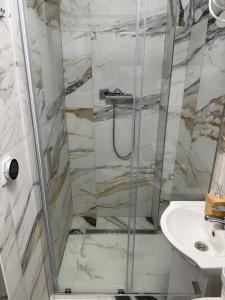 a bathroom with a shower and a sink at Mieszkanie Ratownika in Dziwnów