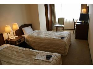 a hotel room with two beds and a television at Ichihara Marine Hotel - Vacation STAY 01375v in Ichihara +68 photos