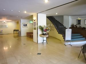 a lobby of a building with a staircase and a table at Ichihara Marine Hotel - Vacation STAY 01375v in Ichihara