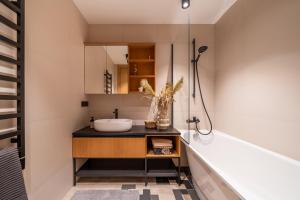 a bathroom with a sink and a mirror at Edinburgh loft-style apartments in Jūrmala +99 photos