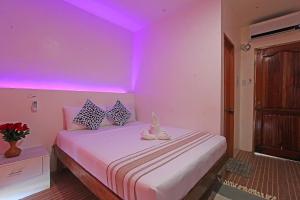 Postel nebo postele na pokoji v ubytování Foxtail Siargao Island Guesthouse