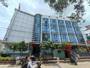 a man riding a motorcycle in front of a building at Hotel Apex Intercontinental in Jaipur