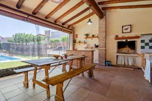 a dining room with a table and a fireplace at Casa Pont in Tarragona