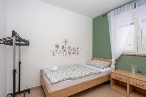 a bedroom with a bed and a window at Villa Sbay in Omišalj