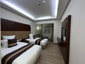 Postel nebo postele na pokoji v ubytování Regardal Hotel