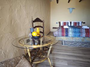 a room with a glass table and a bed at Alturas del Montgo in Denia