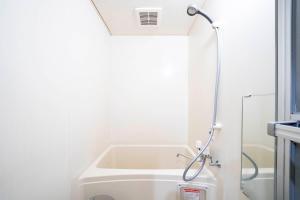 a bath tub in a bathroom with a shower at Silk Court 301 in Chitose