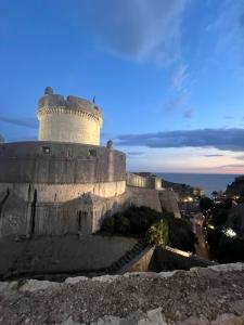 a castle on top of a hill at night at Apartment by CITY WALLS perfect for 2 in Dubrovnik