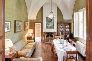 a living room with a table and a couch at La Serra - Villa De Bonis in San Cesario di Lecce