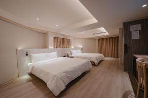 Postel nebo postele na pokoji v ubytování 衿后禾居Good Hotel
