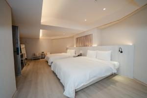 Postel nebo postele na pokoji v ubytování 衿后禾居Good Hotel