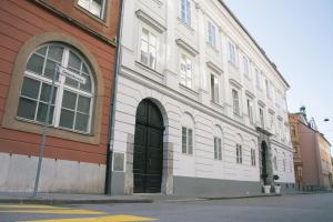 a white building with a black door on a street at modern studio apartment in the heart of old city in Ljubljana