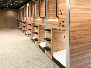 a row of wooden lockers in a room at HOTEL LiVEMAX SAPPORO NAKAJIMA PARK GRANDE in Sapporo