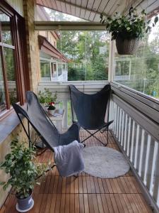 a porch with two chairs and a rug at Two-room apartment with sauna in the Old Town in Savonlinna
