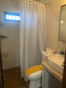 a bathroom with a toilet and a sink and a shower at To σαλέ της λίμνης 2 in Kalyvia Fylaktis +112 photos