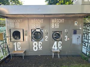a donation station with three washing machines in it at wallerseehomes 110 in Baierham