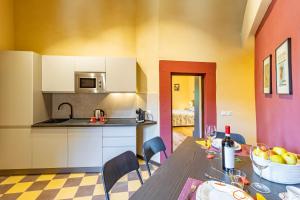 a kitchen and dining room with a table and chairs at Romantic Apartment In Chianti Classico - Happy Rentals in Castelnuovo Berardenga