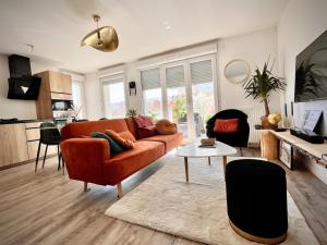 a living room with a couch and a table at New apartment near Paris in Bezons