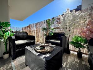 a living room with chairs and a table at New apartment near Paris in Bezons