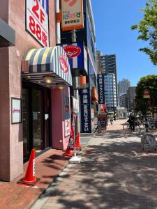 a street with orange cones in front of a building at Tokyo Link House Halona-Direct to Shinjuku, Shibuya, Ginza in Tokyo