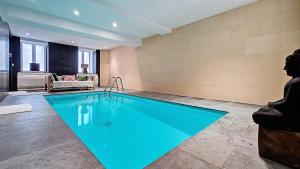 a large swimming pool in a room at Appartement Maison Eugenie in Luchon