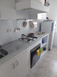 a kitchen with a stove top oven next to a sink at Apartament vila Roma in Eforie Nord