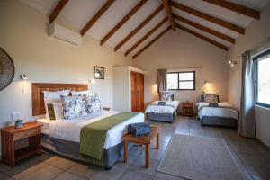 a bedroom with two beds in a room at Tshukudu Bush Camp 