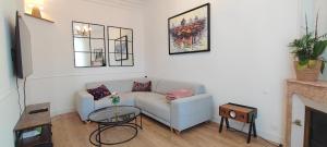 a living room with a couch and a fireplace at Le Petit Clos - Village house in Saint-Geniès in Saint-Geniès