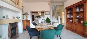 a dining room with a table and chairs and a fireplace at Le Petit Clos - Village house in Saint-Geniès in Saint-Geniès