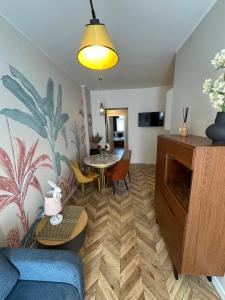a living room with a blue couch and a table at Apartment Chorzow Center in Chorzów