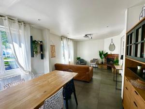 a living room with a wooden table and a couch at La Coloc' in Rouen